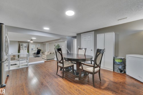 This expansive room features hard surface flooring, recessed lighting, and a neutral color palette - 8807 31 Avenue, Edmonton, AB - Indoor Photo Showing Dining Room