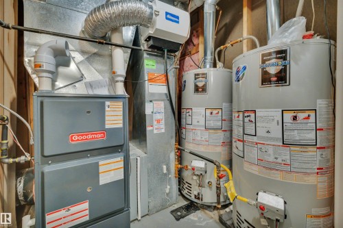 The property includes a Goodman furnace and two water heaters, providing essential home systems - 8807 31 Avenue, Edmonton, AB - Indoor Photo Showing Basement