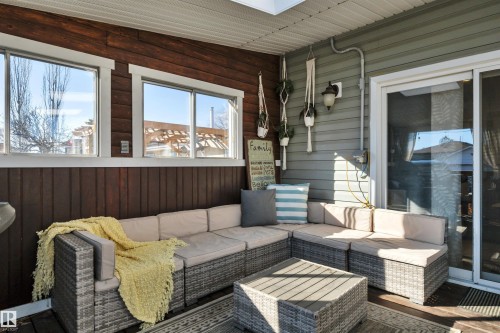 The property features a covered Deck with rich wooden paneling and windows, offering natural light - 8807 31 Avenue, Edmonton, AB - Outdoor With Deck Patio Veranda With Exterior