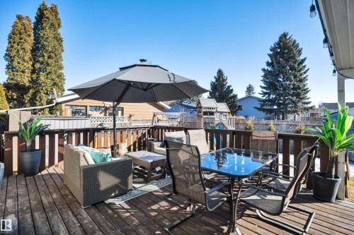 Expansive outdoor deck with a dark wood finish and a wooden railing - 8807 31 Avenue, Edmonton, AB - Outdoor With Deck Patio Veranda With Exterior