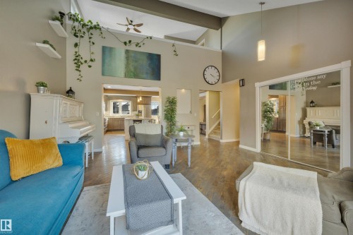 The living area features vaulted ceilings, hardwood floors, and a modern ceiling fan - 8807 31 Avenue, Edmonton, AB - Indoor Photo Showing Other Room