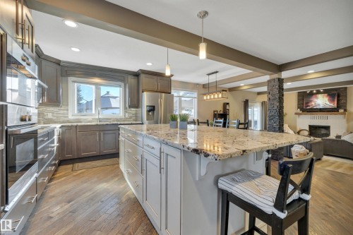 Kitchen featuring hardwood floors, granite countertops, stainless steel appliances, and recessed lighting - 8807 31 Avenue, Edmonton, AB - Indoor Photo Showing Kitchen With Upgraded Kitchen