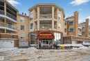 The property features a multi-story exterior with a textured finish, numerous balconies, and integrated garage doors at ground level - 106 15499 Castle Downs Road, Edmonton, AB  - Outdoor With Facade 