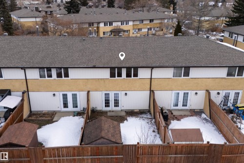 The property features a private fenced yard with a small shed and a patio area, accessible via double French doors - 3301 139 Avenue, Edmonton, AB - Outdoor