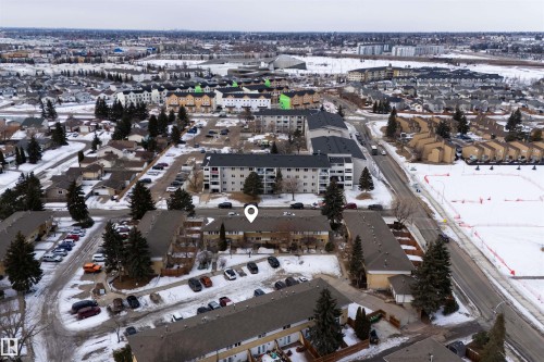 Aerial view highlighting the property's location within a developed neighborhood, featuring residential buildings and paved roads - 3301 139 Avenue, Edmonton, AB - Outdoor With View