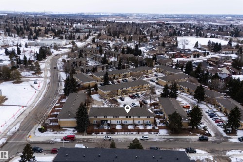 Aerial view of the property and its surrounding neighborhood, featuring townhome-style residences with private decks and nearby parking - 3301 139 Avenue, Edmonton, AB - Outdoor With View
