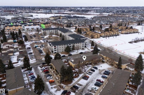 Aerial view of the property and surrounding neighborhood, featuring residential buildings and snow-covered ground - 3301 139 Avenue, Edmonton, AB - Outdoor With View