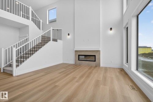 7087 Kiviaq Crescent, Edmonton, AB - Indoor Photo Showing Other Room With Fireplace