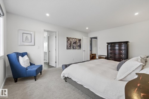 Well-appointed bedroom featuring light-colored carpeting, a window, and recessed lighting - 13 Bilodeau Crescent, Beaumont, AB - Indoor Photo Showing Bedroom