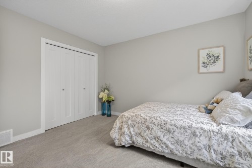 This room features light grey walls and light grey carpet - 13 Bilodeau Crescent, Beaumont, AB - Indoor Photo Showing Bedroom