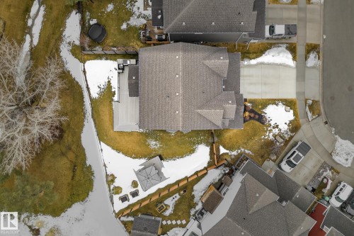Aerial view showcasing the property's roof, an expansive deck, and a well-maintained driveway - 13 Bilodeau Crescent, Beaumont, AB -  With View