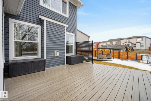 The property features a spacious deck with light-toned decking, extending from the side of the home - 13 Bilodeau Crescent, Beaumont, AB - Outdoor With Exterior