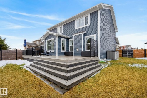 This property features a composite deck with wide steps descending to a lawn - 13 Bilodeau Crescent, Beaumont, AB - Outdoor