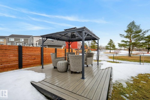 The property features a spacious deck with a gazebo, offering an outdoor living space - 13 Bilodeau Crescent, Beaumont, AB - Outdoor