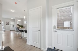 The property features an open concept living area with light-toned flooring, recessed lighting, and pendant light fixtures - 