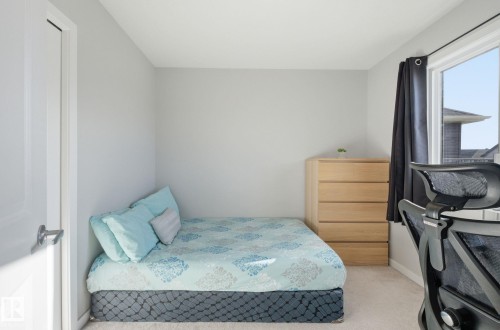 This room features light colored walls, a window with a dark curtain, and carpeting - 17498 76 St Nw, Edmonton, AB - Indoor Photo Showing Bedroom