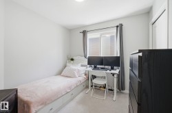 This room features light-colored walls and a window with blinds and drapes - 