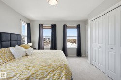 This room features light-colored walls, carpeted flooring, and a ceiling-mounted light fixture - 