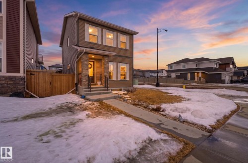 The property features a two-story exterior with horizontal siding and stone accents - 17498 76 St Nw, Edmonton, AB - Outdoor