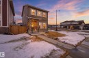 The property features a two-story exterior with horizontal siding and stone accents - 17498 76 St Nw, Edmonton, AB  - Outdoor 