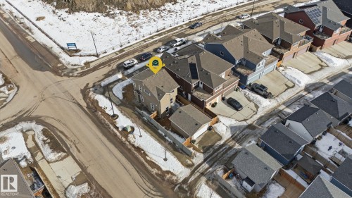 Aerial view of the property and its surrounding neighborhood, featuring a corner lot location and a detached garage - 17498 76 St Nw, Edmonton, AB - 