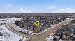 An aerial view showcasing a residential neighborhood with detached properties and paved streets - 