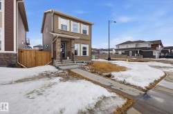 This property features a two-story exterior with brown siding and white trim windows - 