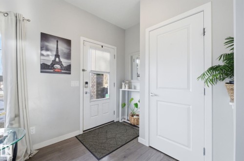 Entryway featuring a white door with a window, light gray walls, and hardwood style flooring - 17498 76 St Nw, Edmonton, AB - Indoor Photo Showing Other Room