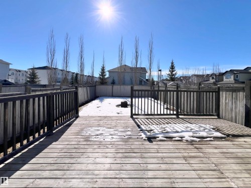 The property includes a wooden deck with railing, opening to a fenced yard - 17127 7A Avenue, Edmonton, AB - Outdoor With Exterior