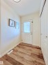 The entryway features wood-look flooring, a white paneled door with a window, and white walls - 17127 7A Avenue, Edmonton, AB  - Indoor Photo Showing Other Room 
