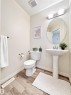 The property features a powder room with wood-style flooring and a pedestal sink - 17127 7A Avenue, Edmonton, AB  - Indoor Photo Showing Bathroom 