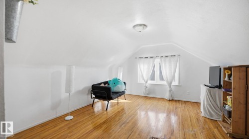 This room features hardwood floors and a window providing natural light - 10922 117 Street, Edmonton, AB - Indoor Photo Showing Other Room