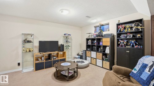 The room features light-colored carpeting and walls, along with recessed lighting - 10922 117 Street, Edmonton, AB - Indoor