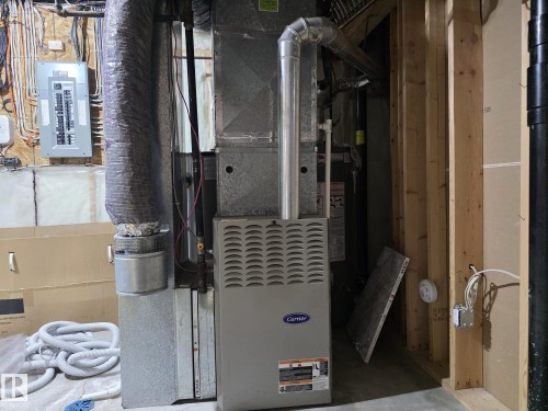 The property includes a Carrier-branded furnace and a visible electrical panel - 4477 36 Street, Drayton Valley, AB - Indoor Photo Showing Basement