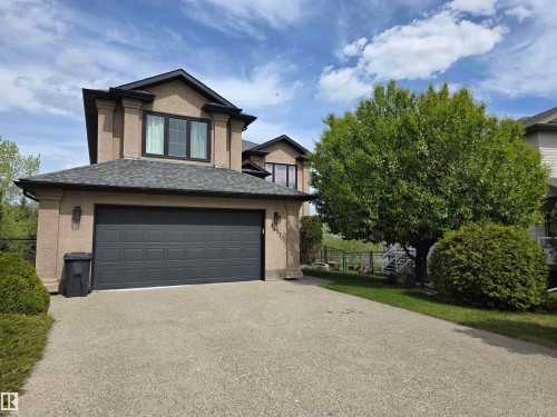 Two-story residence featuring a dark asphalt shingle roof and stucco exterior - 4477 36 Street, Drayton Valley, AB - Outdoor