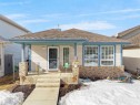 The property features a front porch with decorative columns, a front door with a screen door, and large windows with grilles - 13040 34 Street, Edmonton, AB  - Outdoor With Deck Patio Veranda 