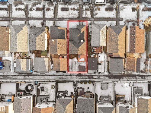 Aerial view of the property, featuring a pitched roof and a paved area at the rear - 13040 34 Street, Edmonton, AB - 