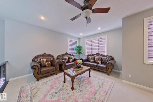 Living area with light-colored walls, recessed lighting, and a ceiling fan - 1743 60 Street Sw, Edmonton, AB - Indoor Photo Showing Living Room