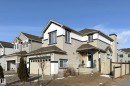 This property features a two-story design with light-colored siding and dark trim accents - 1743 60 Street Sw, Edmonton, AB  - Outdoor 
