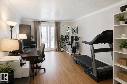 Versatile room featuring hardwood floors, crown molding, and double glass panel doors providing access to the outdoors - 13204 131A Avenue, Edmonton, AB - Indoor Photo Showing Other Room