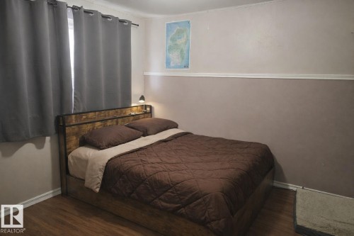 This room features wood-style flooring and a window with curtains - 13204 131A Avenue, Edmonton, AB - Indoor Photo Showing Bedroom