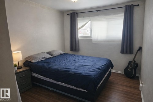 This room features hard surface flooring, a window with curtains, and a ceiling light fixture - 13204 131A Avenue, Edmonton, AB - Indoor Photo Showing Bedroom