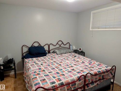 This room features light grey walls and parquet flooring - 10645 65 Avenue, Edmonton, AB - Indoor Photo Showing Bedroom