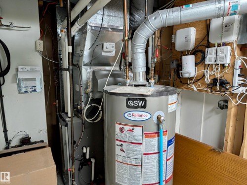 The property features a water heater and furnace, providing essential utilities - 10645 65 Avenue, Edmonton, AB - Indoor Photo Showing Basement