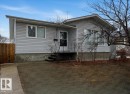 The property features light-colored horizontal siding, a gabled roof, and a front entrance with a metal railing - 10645 65 Avenue, Edmonton, AB  - Outdoor 