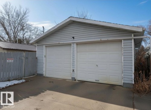 The property includes a detached garage with two overhead doors - 10645 65 Avenue, Edmonton, AB - Outdoor With Exterior