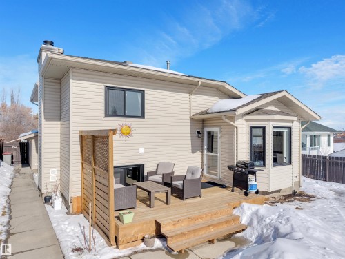 The property features a private deck with outdoor seating, a bay window, and light-colored siding - 131 West Liberty Crescent, Millet, AB - Outdoor With Deck Patio Veranda