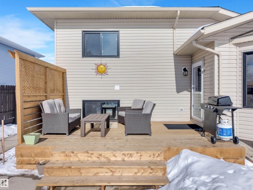 The property features an exterior deck with wooden privacy screening and steps - 131 West Liberty Crescent, Millet, AB - Outdoor With Deck Patio Veranda With Exterior