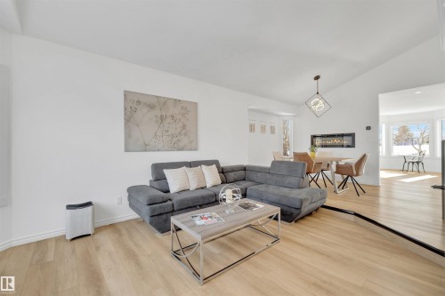 This inviting living space features light wood flooring and crisp white walls, offering a bright and expansive feel - 131 West Liberty Crescent, Millet, AB - Indoor Photo Showing Living Room