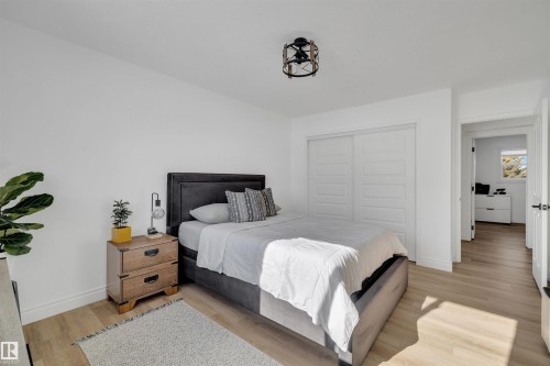 This room features light wood flooring and white walls, creating a bright atmosphere - 131 West Liberty Crescent, Millet, AB - Indoor Photo Showing Bedroom